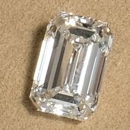 a loose emerald cut diamond photographed in our showroom
