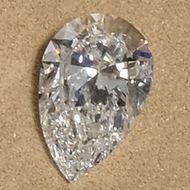 a loose pear cut diamond photographed in our showroom