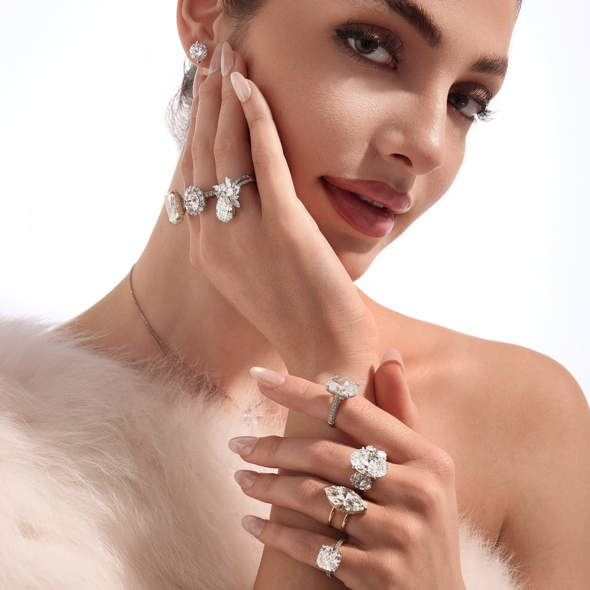 A model wearing several diamond rings and a diamond bracelet