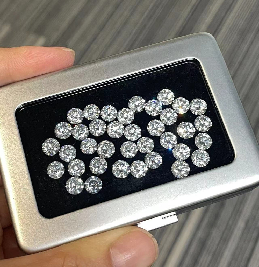 A loose diamond held in tweezers above a stone case, with laboratory certificates alongside