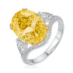 Ring with a large yellow diamond and smaller diamonds on a white background